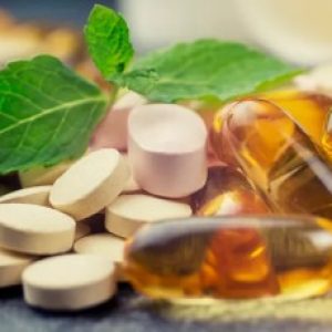 pills and multivitamins on a dark background, closeup