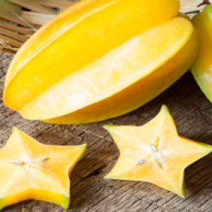 star fruit and piece with it's flower and leaf on old wood